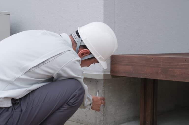 A foundation repair contractor working on repairs